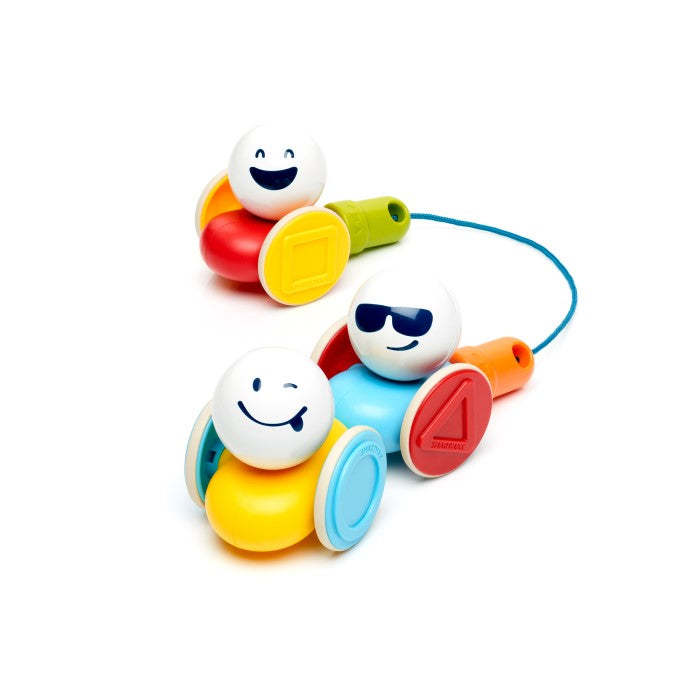 Vibrant magnetic toy cars featuring white emoji-faced balls, shaped wheels, and a blue pull string.