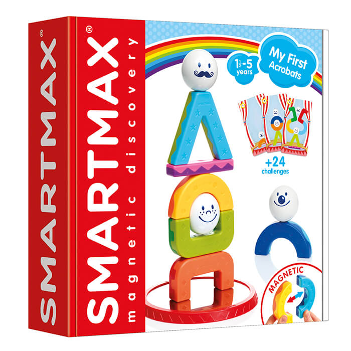 Red toy box featuring a tower of colorful magnetic arches, triangles, and smiley face balls on a mirrored base.