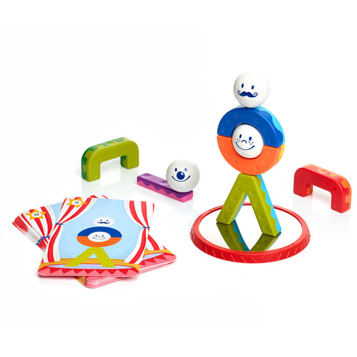 Magnetic building set with colorful curved bars, balls with faces, challenge cards, and a mirror base.