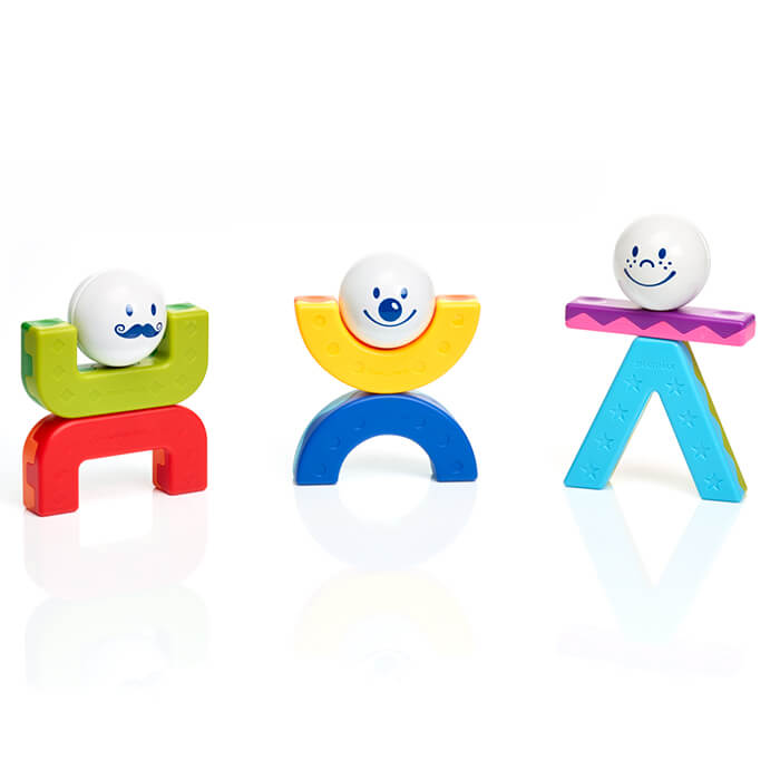 Three magnetic toy figures with white ball heads and blue faces, built from colorful arches, bars, and geometric shapes.