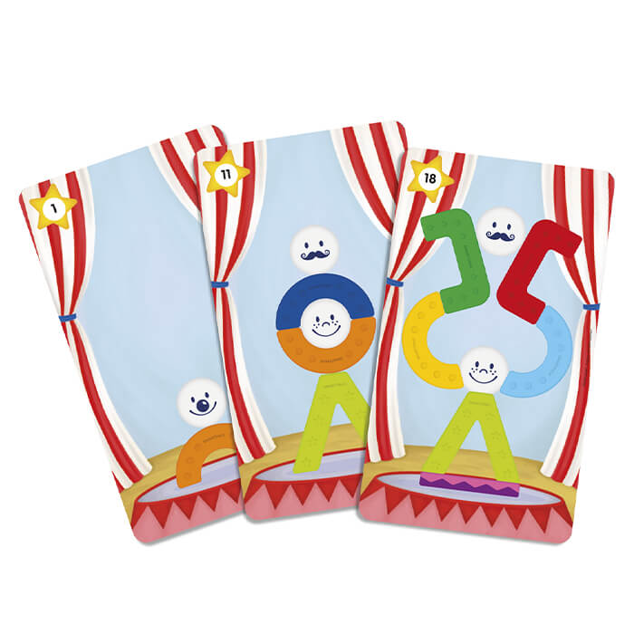 Three circus cards show colorful magnetic toy towers built from geometric shapes and balls with smiley faces.