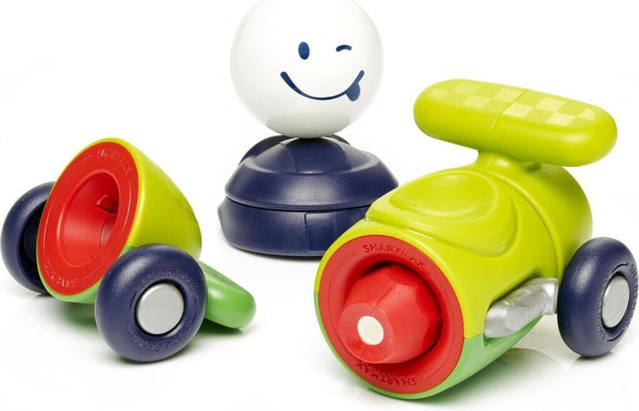 Green and red magnetic toy car parts with blue wheels and a white winking driver figure.