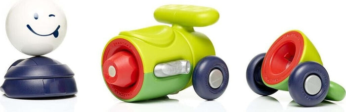 Three chunky magnetic toy pieces: a winking white face, a lime green car body with red trim, and a blue-wheeled base.