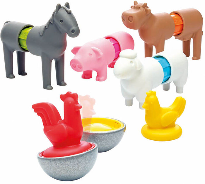 Colorful magnetic toy farm animals: grey horse, pink pig, brown cow, white sheep, plus red and yellow chickens on bases.