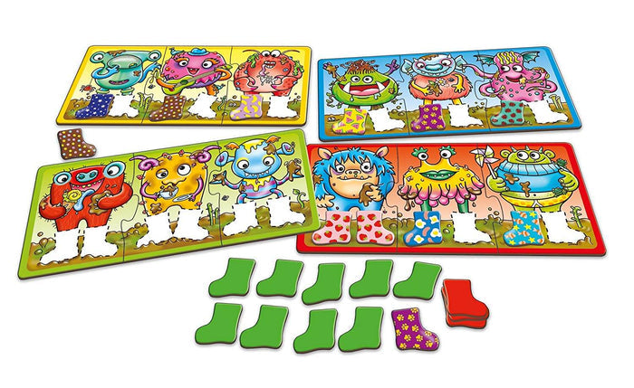 Four colorful game boards featuring monsters with patterned welly boots and loose matching boot-shaped tiles.