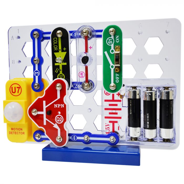 Assembled circuit project on a white grid with a yellow motion sensor, red transistor, and green switch.