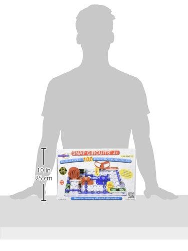 Snap Circuits Jr. box showing colorful electronic parts on a grid, next to a person silhouette and 10-inch scale marker.