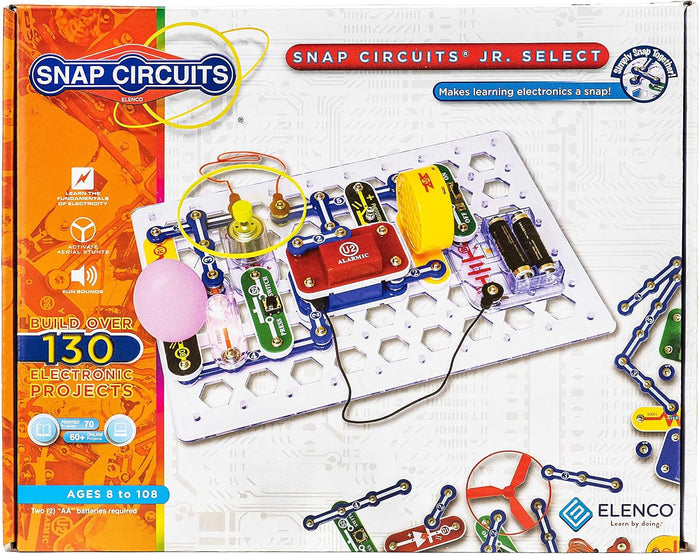 Snap Circuits Jr. Select box showing an assembled electronic circuit with red, blue, and yellow modules on a white grid.