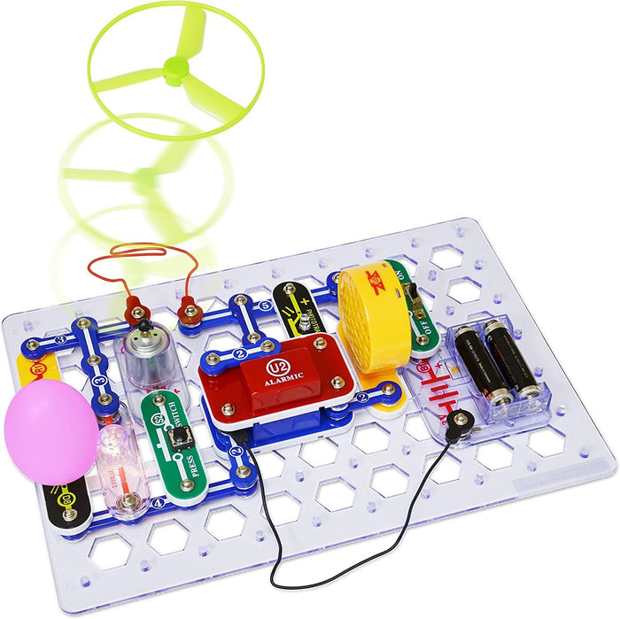 Colorful electronic snap modules on a clear base plate featuring a green propeller fan taking flight.