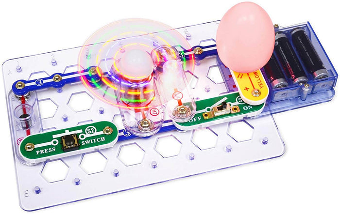 Snap-together electronic kit with a light-up spinning fan, colorful components, and battery pack on a clear baseplate.