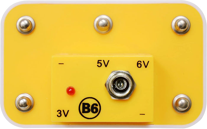 Yellow Snap Circuits module with six metal snaps, a power jack, a red LED light, and 3V, 5V, and 6V voltage labels.