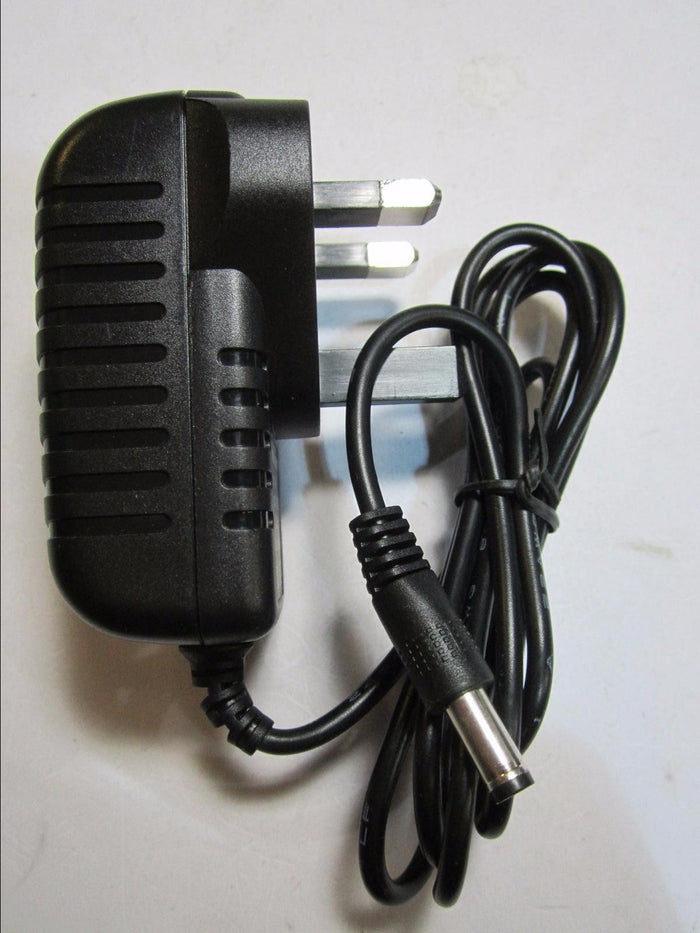 Black power adapter with a UK 3-pin plug and a long black cable ending in a silver barrel connector.