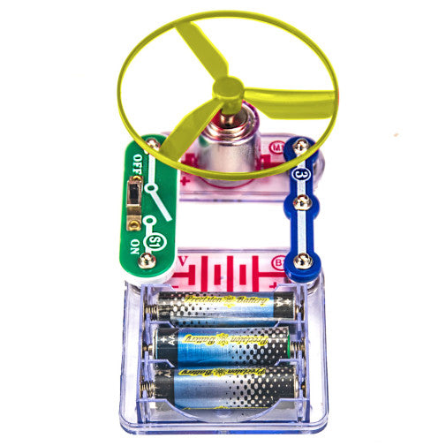 Electric circuit toy with three AA batteries, a green slide switch, and a yellow propeller fan on a central motor.