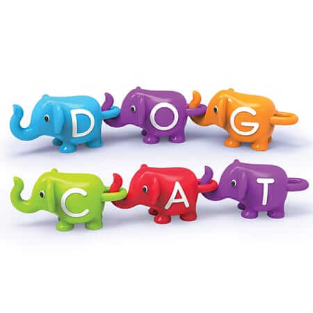 Colorful toy elephants snapped together trunk-to-tail to spell DOG and CAT in white capital letters.