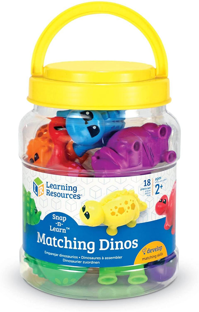 Clear storage bucket with a yellow handle filled with colorful, snap-together plastic toy dinosaurs.