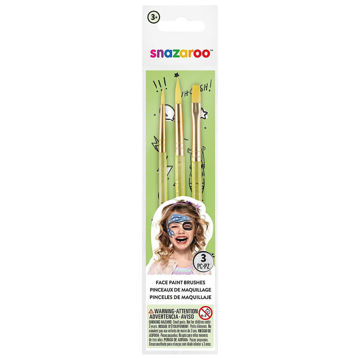 Three face paint brushes with light green handles and golden bristles in white packaging with a girl's painted face.