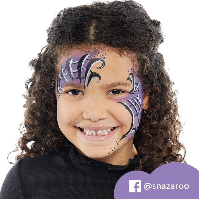 Smiling girl with curly hair wearing purple, black, and white graphic face paint on her forehead and cheek.