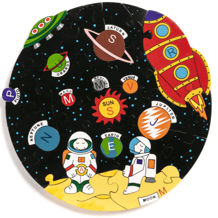 Circular jigsaw puzzle with colorful planets, a red rocket, and two astronauts on a moon against a starry black background.
