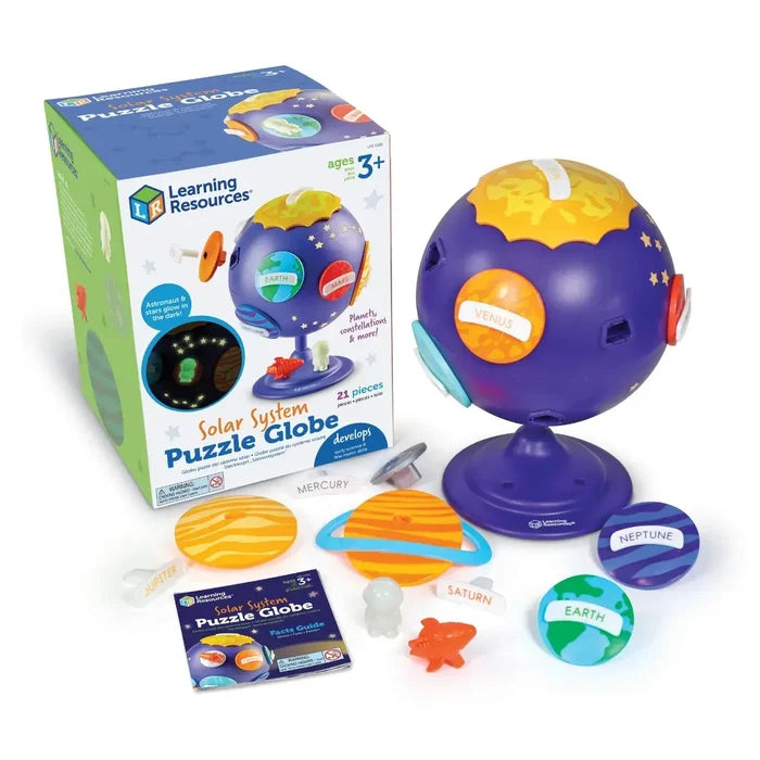 Purple globe toy with colorful planet puzzle pieces, astronaut, and orange rocket next to its retail box.