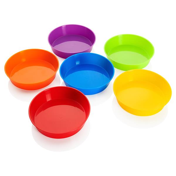 Six shallow round plastic bowls in purple, green, orange, blue, red and yellow on a white reflective surface.