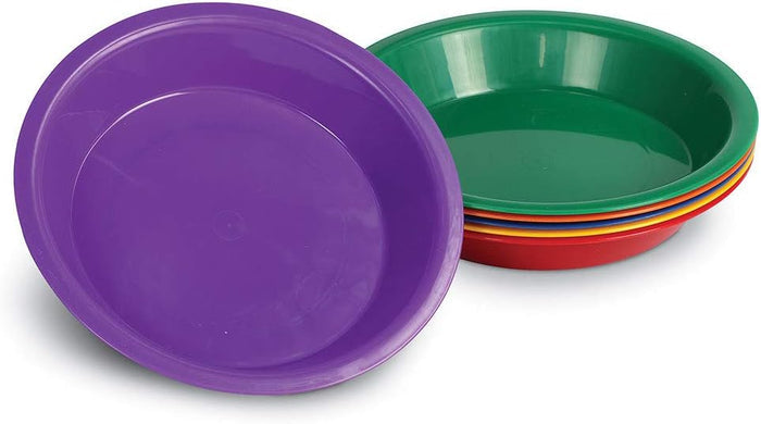 Six shallow round plastic bowls in purple, green, blue, yellow, orange, and red, stacked and tilted forward.