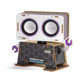 DIY wooden robot speaker with circular speaker eyes, purple claw hands, and a grey honeycomb patterned body.