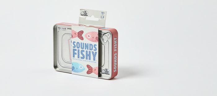 Rectangular silver metal game tin with pink sides and a white sleeve featuring blue text and pink and blue fish.