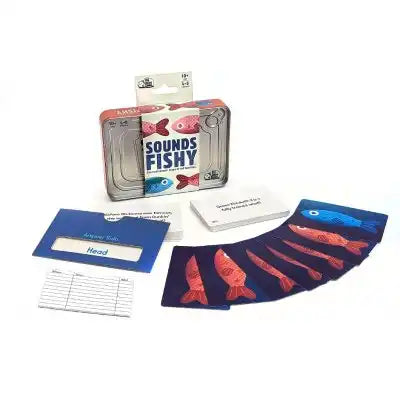 Travel game in a metal tin with fish-illustrated cards, question cards, and a blue card sleeve on a white background.