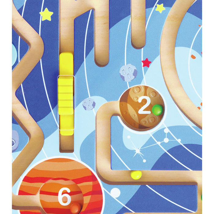 Close-up of a wooden space maze toy featuring colorful numbered planets and a yellow slider in carved tracks.