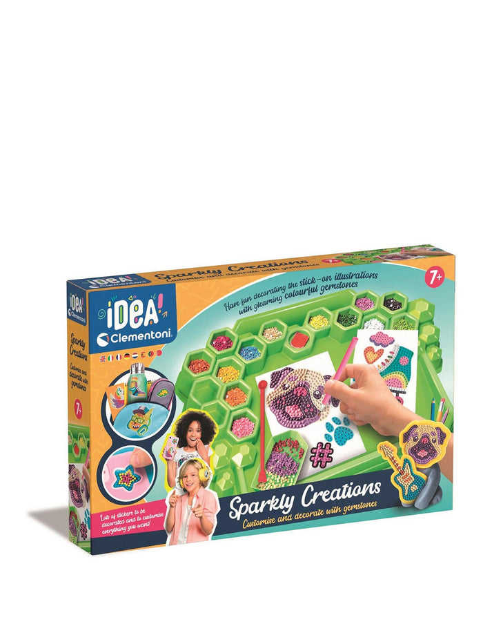 Box for a gem art kit showing a green tray of colorful gemstones used to decorate pug and guitar stickers.