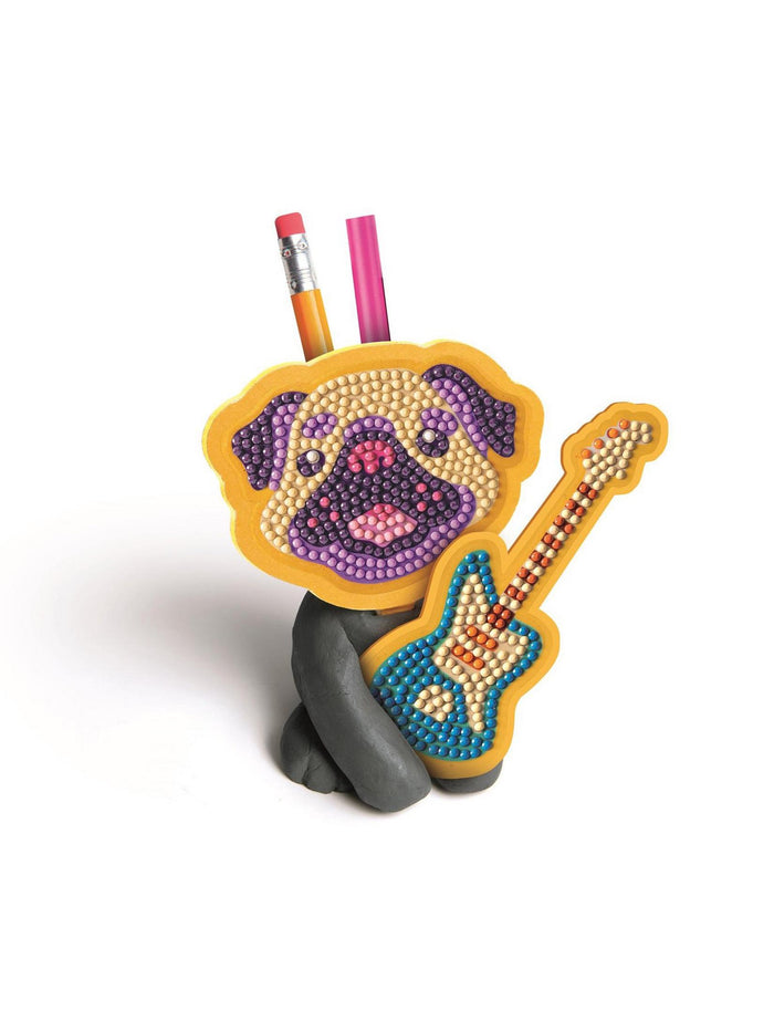 Pug-shaped pencil holder playing a guitar, covered in colorful gems with a yellow border and gray base.
