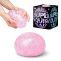 Hands squeeze a pink sparkly squish ball beside its black box, with a large round pink glittery ball below.