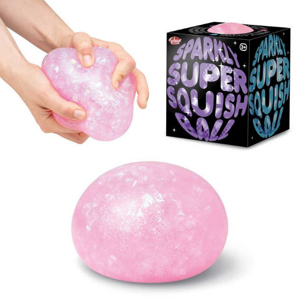 Hands squeeze a pink sparkly squish ball beside its black box, with a large round pink glittery ball below.
