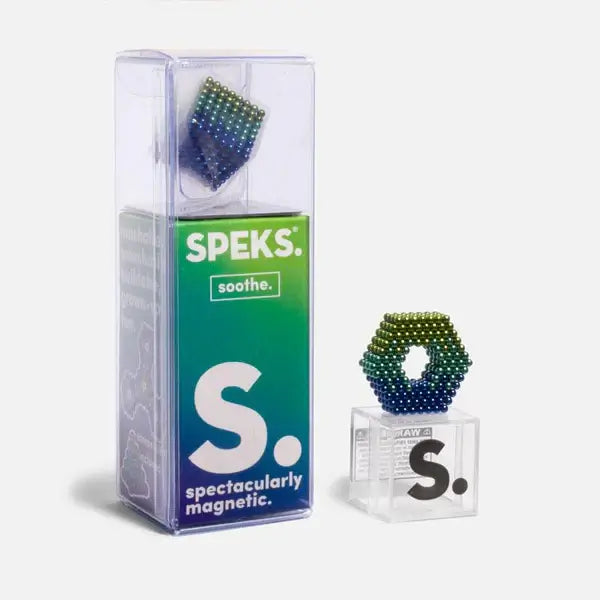 Blue and green gradient magnetic balls in tall clear packaging and formed into a hollow hexagon on a small cube.