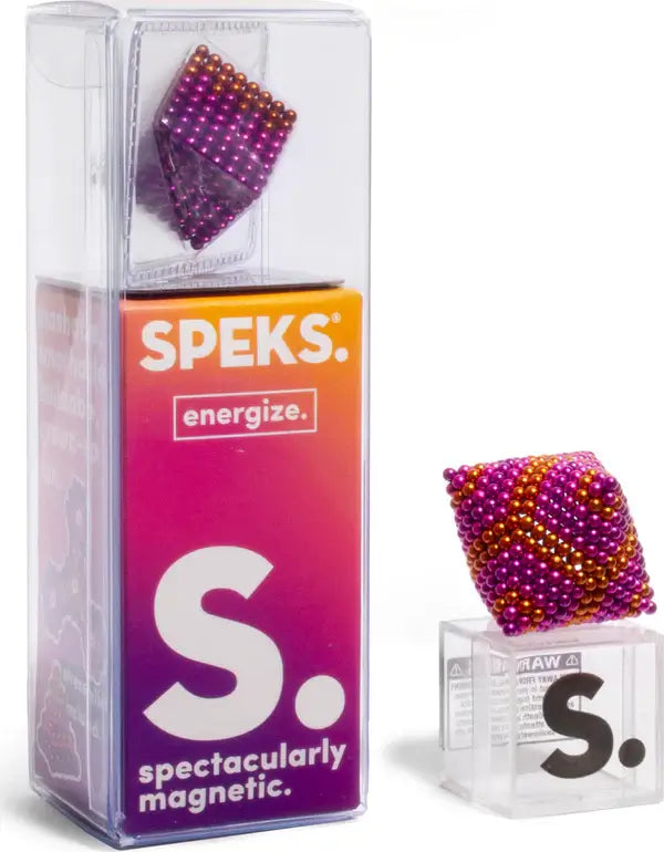 Gradient pink and gold magnetic balls in a clear tall box and formed into a cube on a transparent display stand.