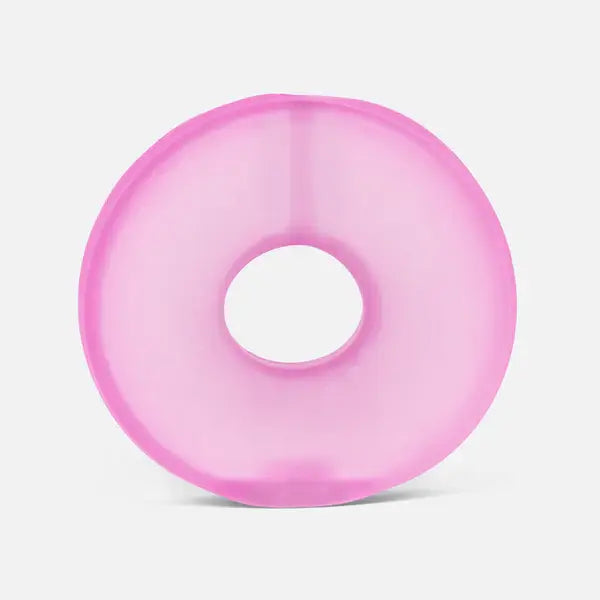 Translucent bright pink, donut-shaped gel ring with a hollow center on a plain white background.
