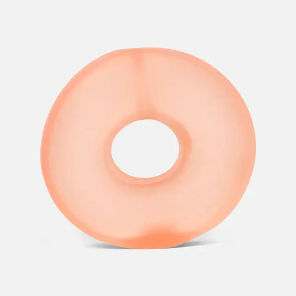 A translucent peach-colored, doughnut-shaped gel loop with a soft matte finish.