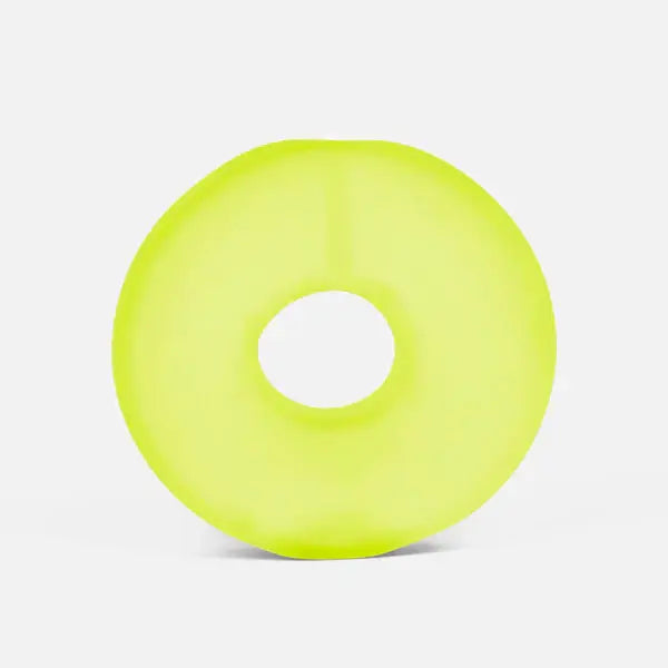 Neon yellow-green doughnut-shaped stress loop with a soft matte finish on a plain white background.