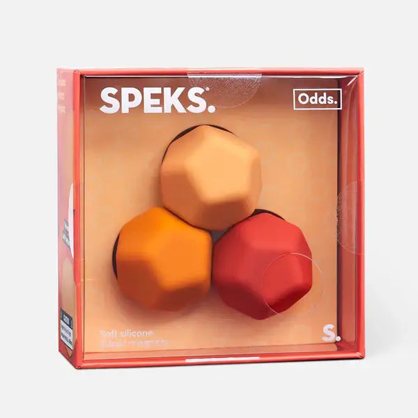 Three faceted silicone magnets in orange, peach, and red inside a clear square box with the Speks brand name.