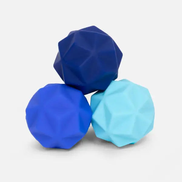 Three faceted silicone fidget balls in shades of dark, royal, and light blue stacked on a white background.