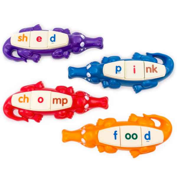 Four colorful toy alligators with letter tiles on their backs spelling shed, pink, chomp, and food.