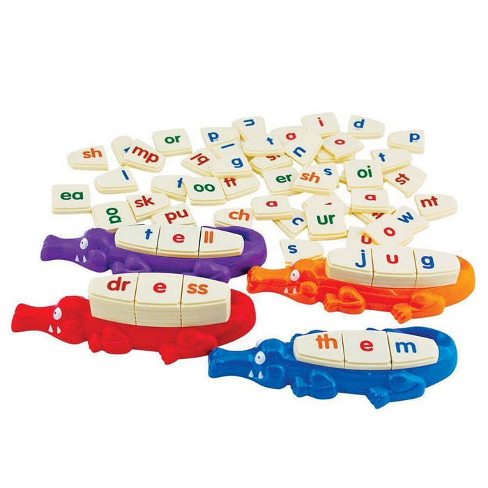 Four colorful alligators holding letter tiles to spell words, surrounded by many white phonics tiles.