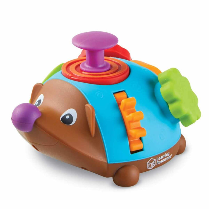 Hedgehog toy with a brown face, blue shell, purple plunger, orange gear, and green knob on a white background.