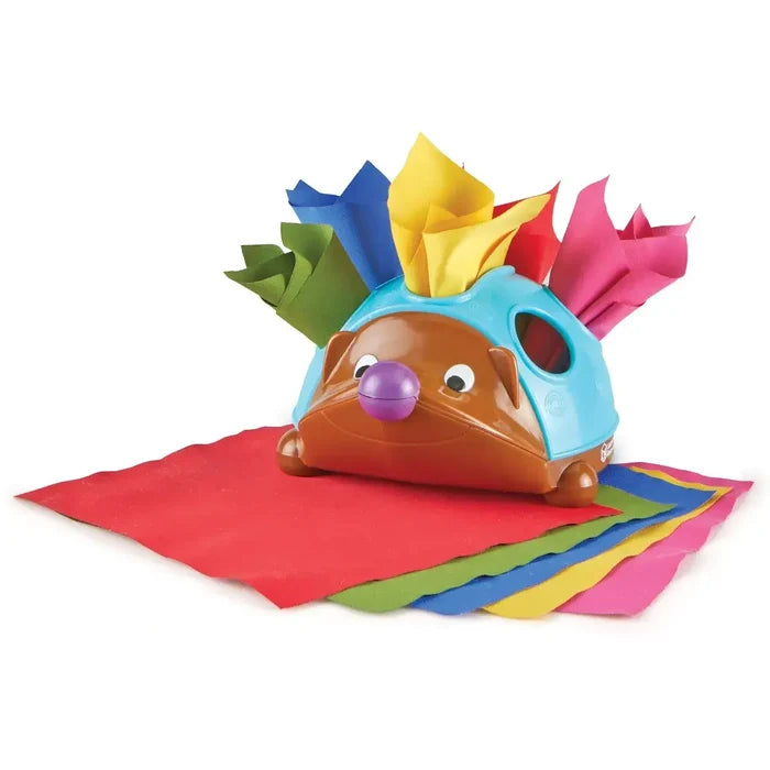 Hedgehog toy with a blue shell, purple nose, and colorful fabric tissues tucked inside and stacked in front.