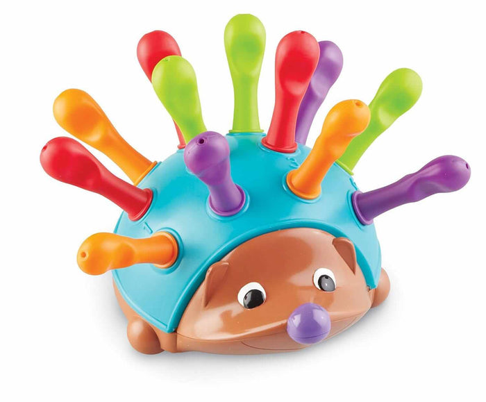 Toy hedgehog with a blue shell and twelve colorful plastic pegs in red, orange, green, and purple.