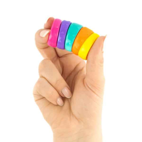Hand holding five vibrant round discs in pink, purple, teal, orange, and yellow against a white background.