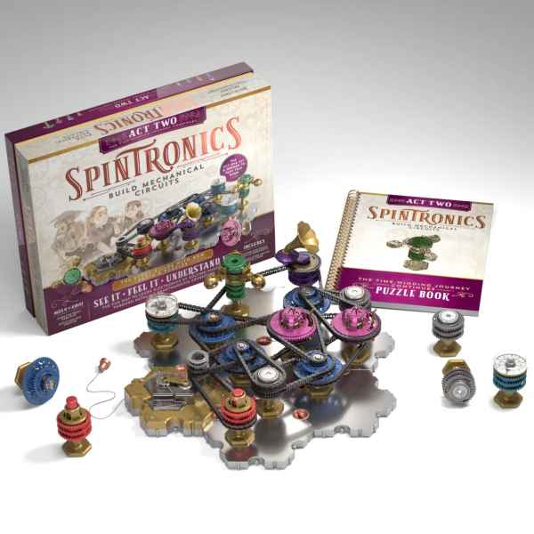 Spintronics Act Two box and puzzle book next to an assembled mechanical circuit with colorful gears and black belts.