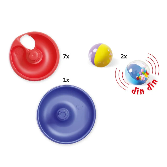 Seven red spiral ramp tiers, a blue base, and two colorful balls, one containing tiny rattling beads.