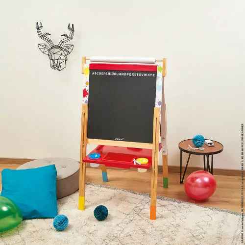 Adjustable wooden easel with a chalkboard, top paper roll, and a red tray with colorful cups in a playroom.