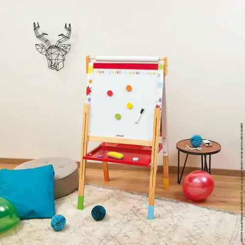 Adjustable wooden toy easel featuring a white magnetic board, red tray, and colorful magnets in a bright playroom.